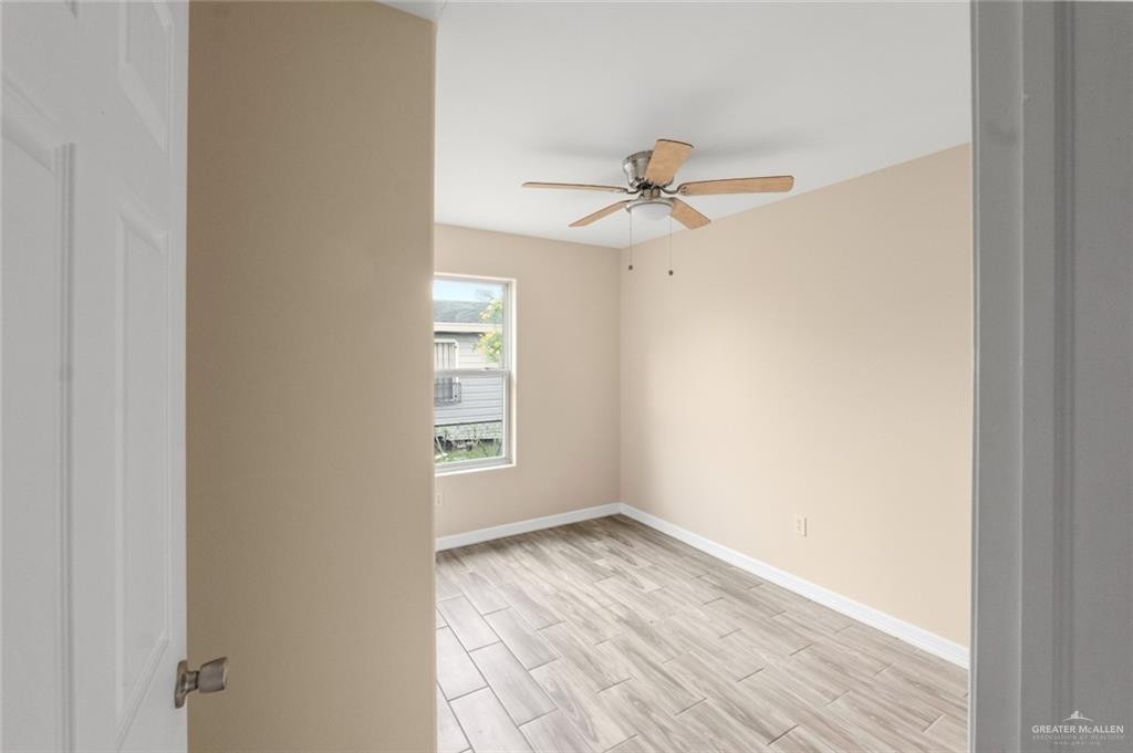 811 Carlson Street Elsa, TX 78538 - Photo 10 of 10 a view of a room with wooden floor and ceiling fan