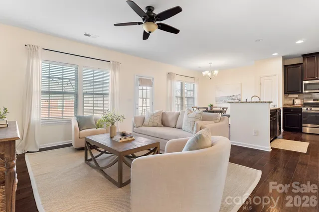 a living room with fireplace furniture and a wooden floor