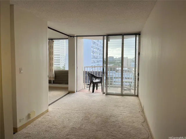 an empty room with windows and closet