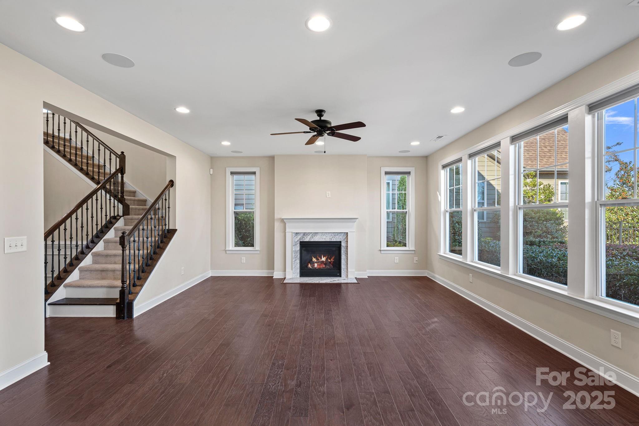 16909 Setter Point Lane Davidson, NC 28036 - Photo 12 of 45 a view of an empty room with wooden floor fireplace and a window