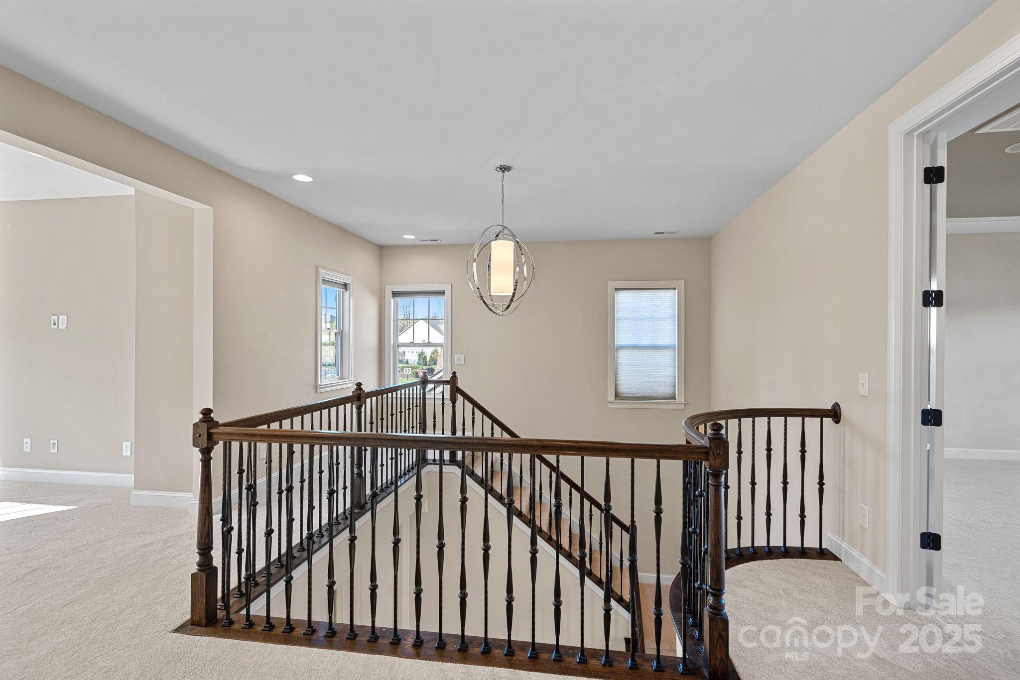 16909 Setter Point Lane Davidson, NC 28036 - Photo 15 of 45 a view of staircase with railing and a chandelier