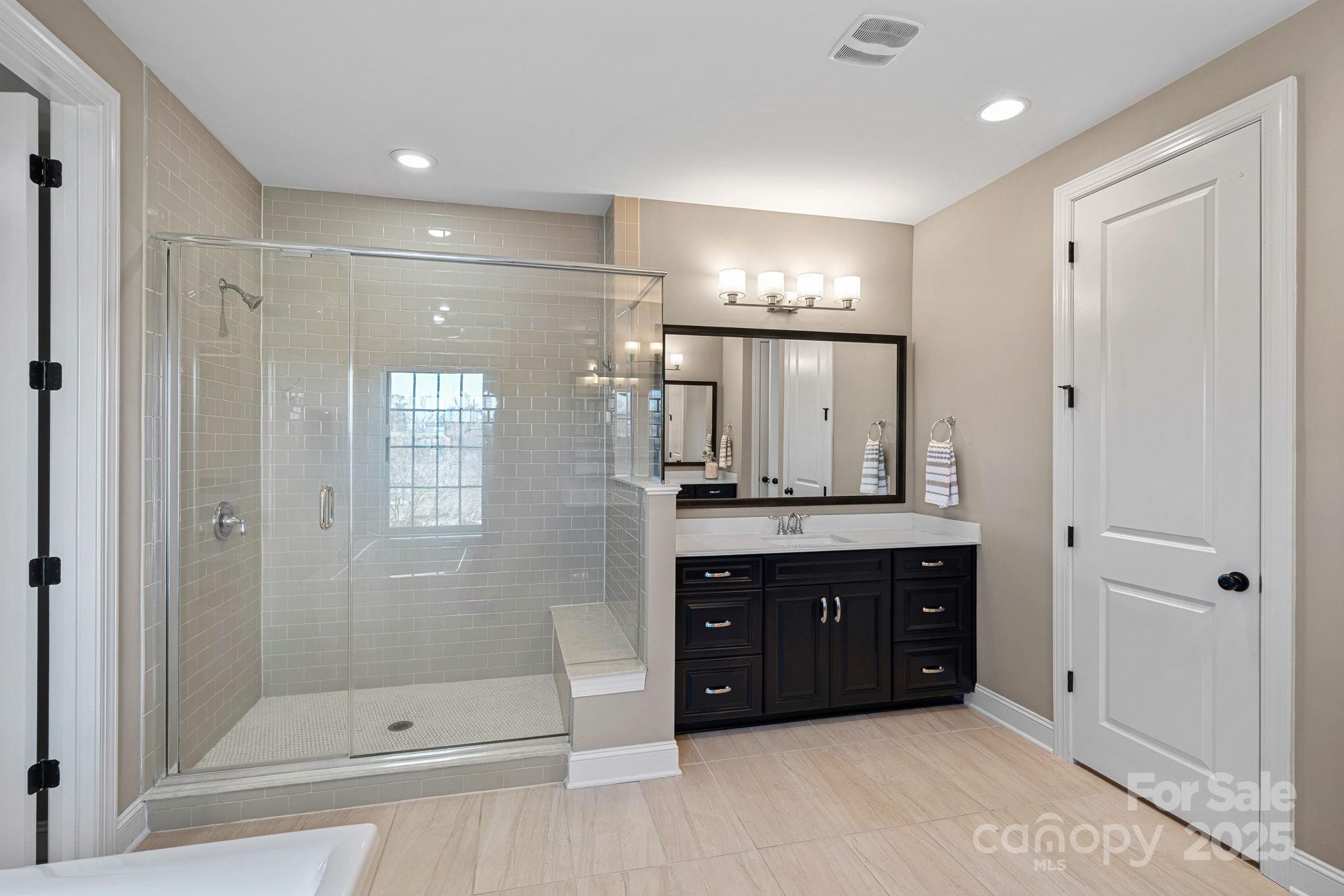16909 Setter Point Lane Davidson, NC 28036 - Photo 21 of 45 a bathroom with a double vanity sink mirror and shower