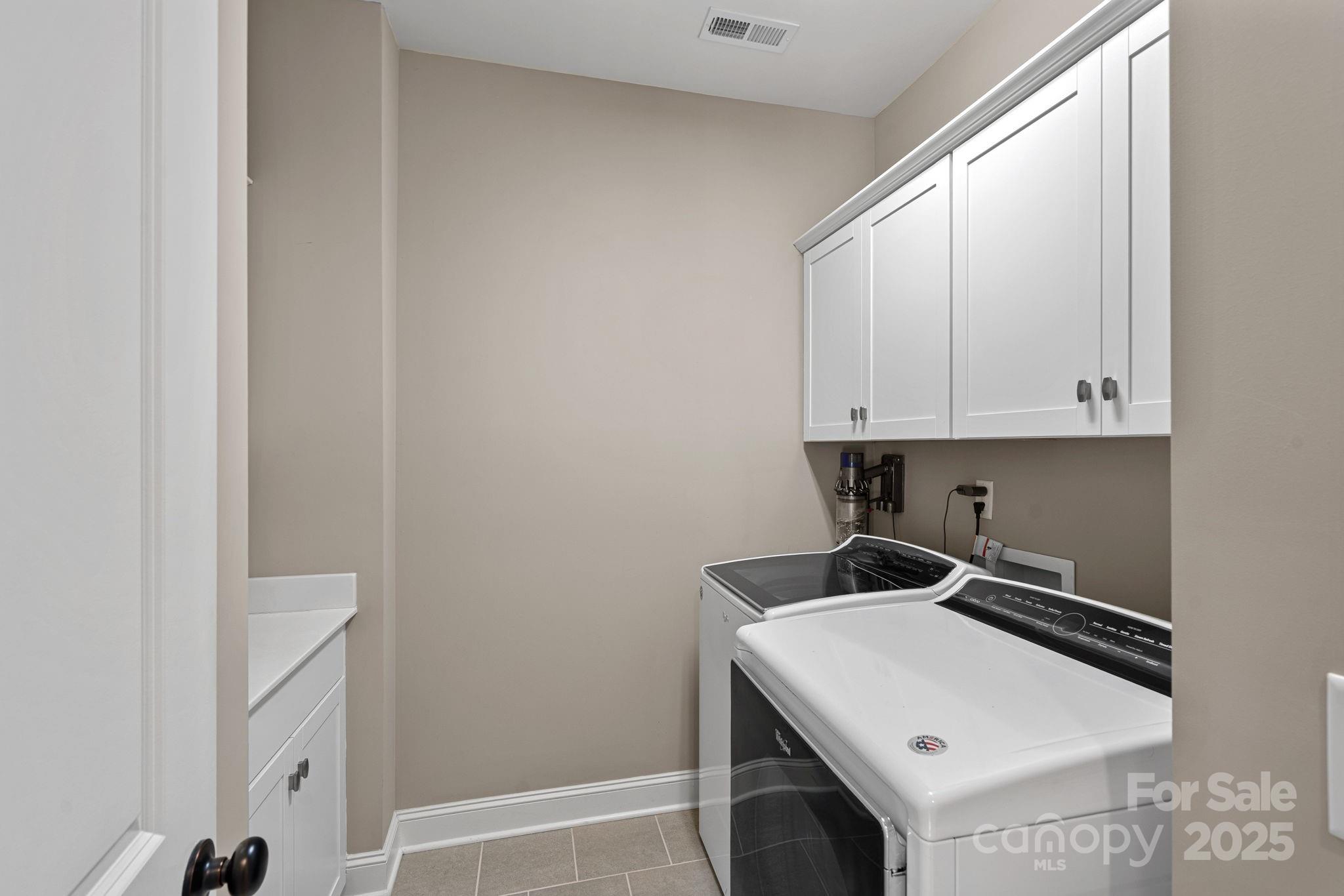 16909 Setter Point Lane Davidson, NC 28036 - Photo 25 of 45 a room with a sink a stove and cabinets