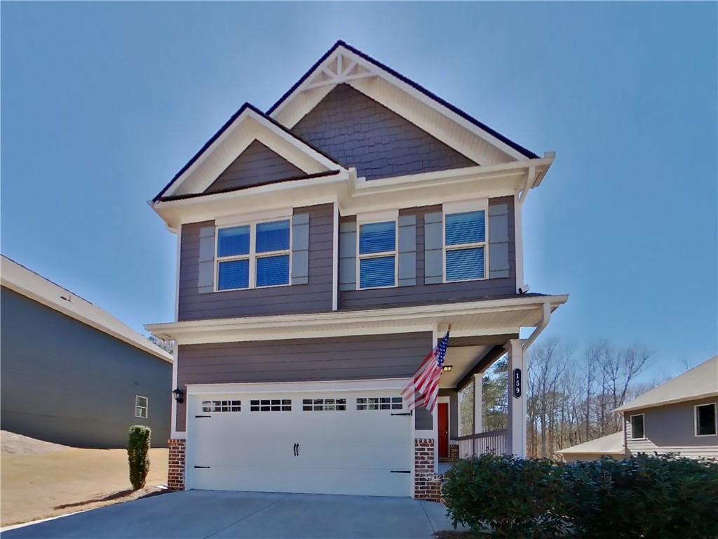 a view of a house with a garage and deck
