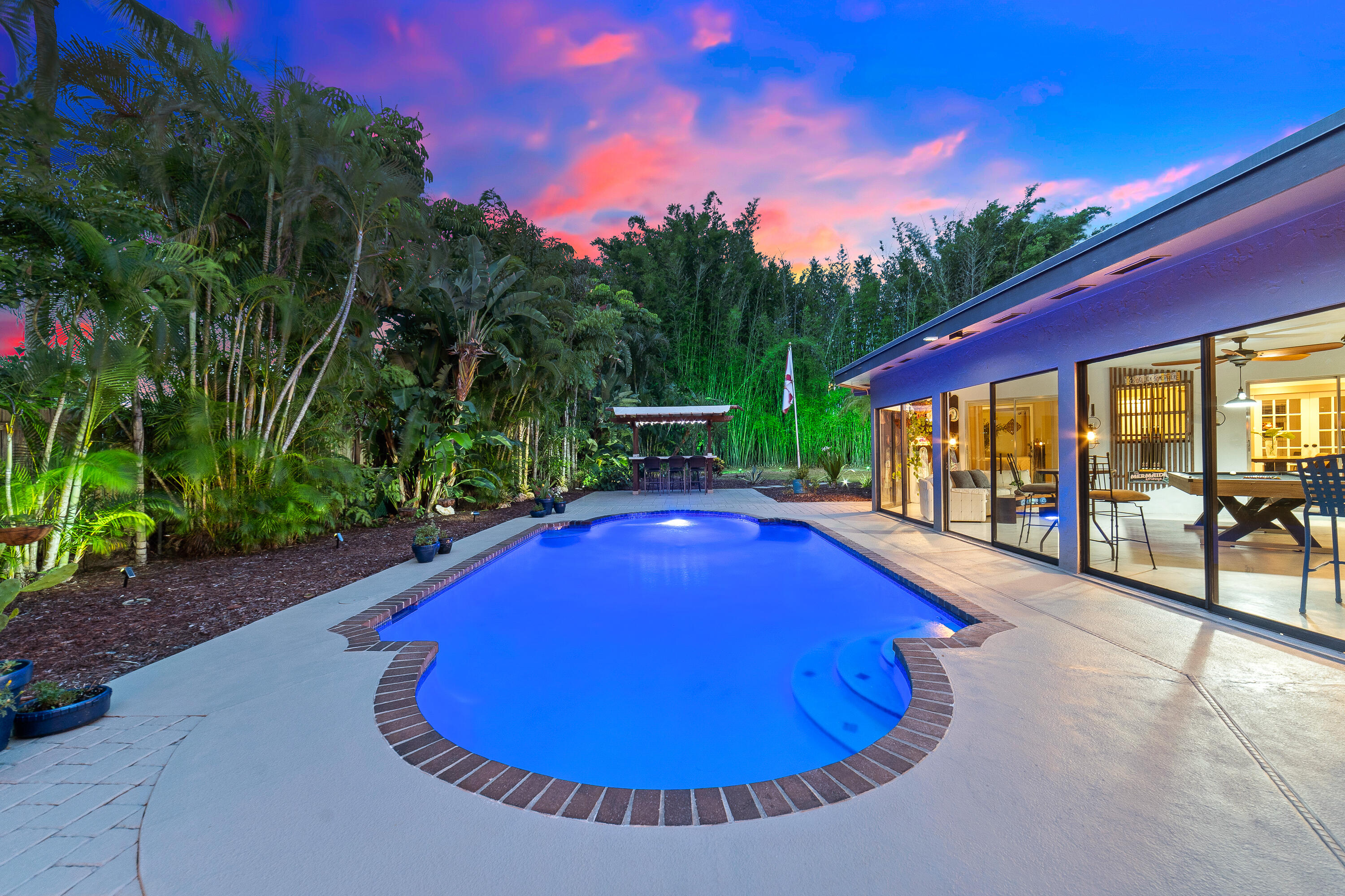 1721 Southwest 9th Street Boca Raton, FL 33486 - Photo 2 of 40 a view of a swimming pool with an outdoor space and seating area