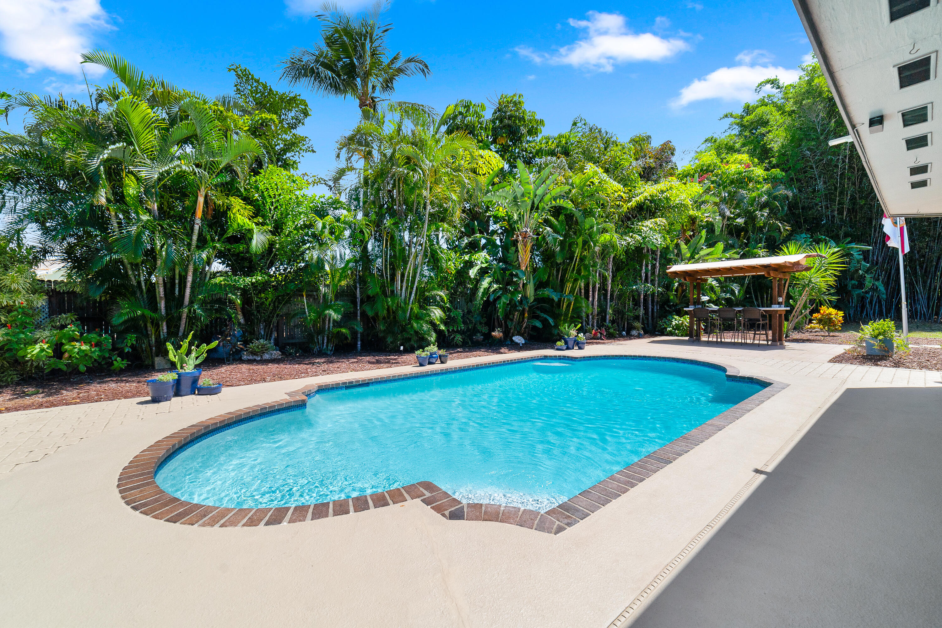 1721 Southwest 9th Street Boca Raton, FL 33486 - Photo 25 of 40 a view of a swimming pool with a yard and sitting area