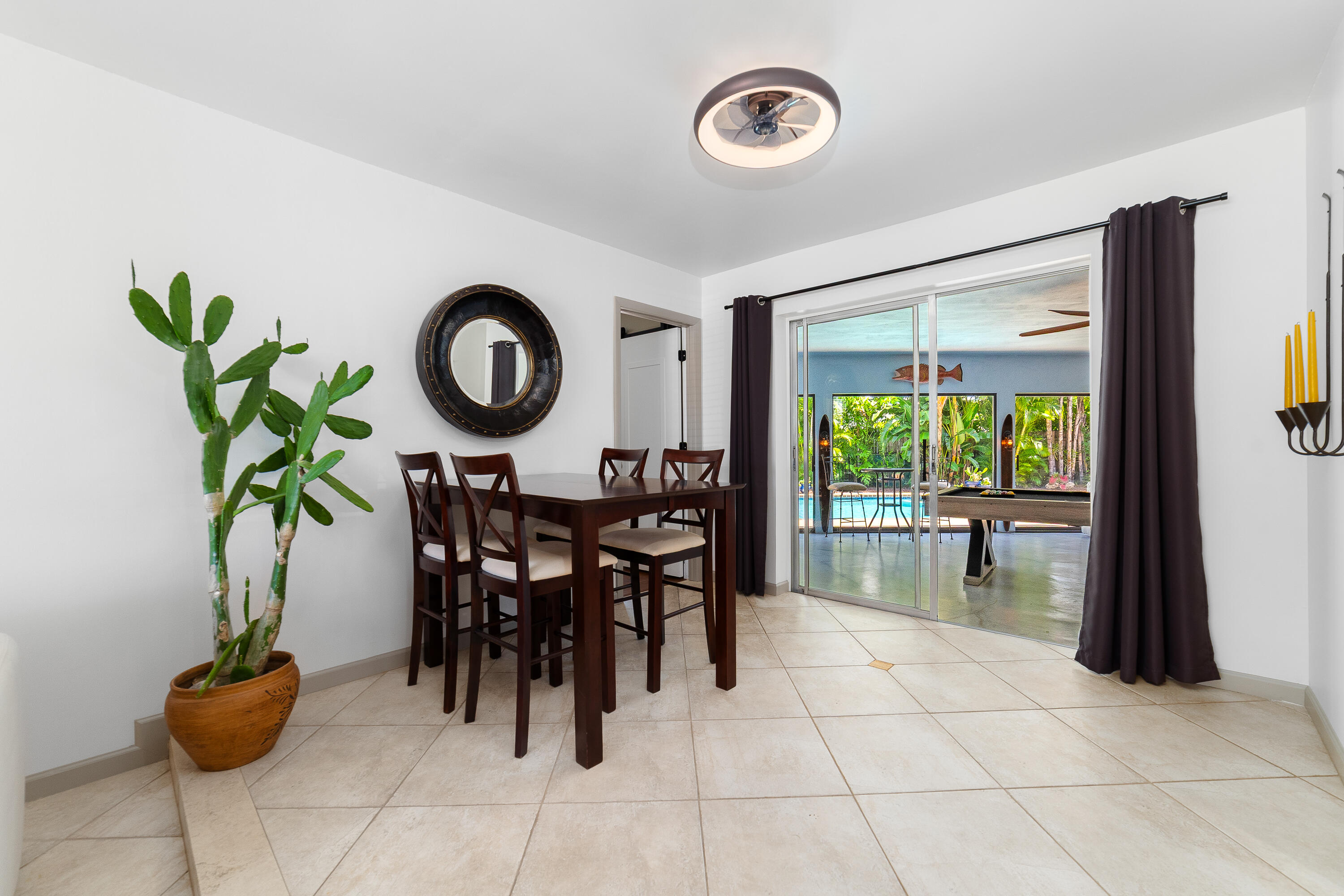 1721 Southwest 9th Street Boca Raton, FL 33486 - Photo 6 of 40 a view of a dining room with furniture and a floor to ceiling window