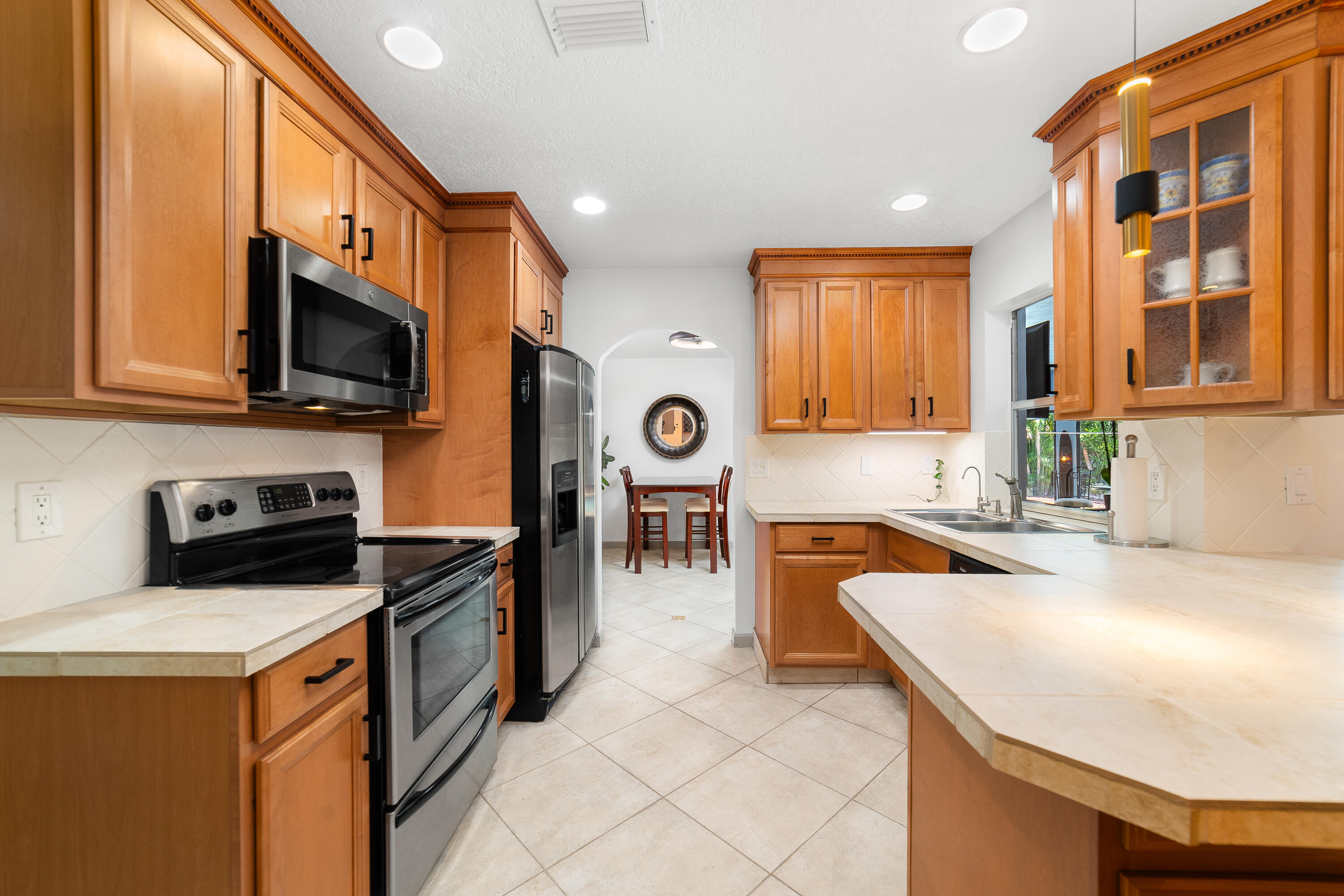 1721 Southwest 9th Street Boca Raton, FL 33486 - Photo 8 of 40 a kitchen filled a sink a microwave a stove and cabinets