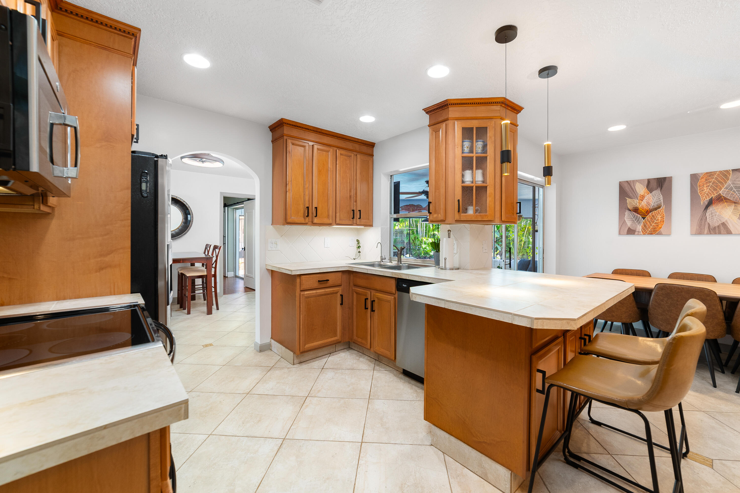 1721 Southwest 9th Street Boca Raton, FL 33486 - Photo 9 of 40 a kitchen with stainless steel appliances granite countertop a sink a stove and a refrigerator