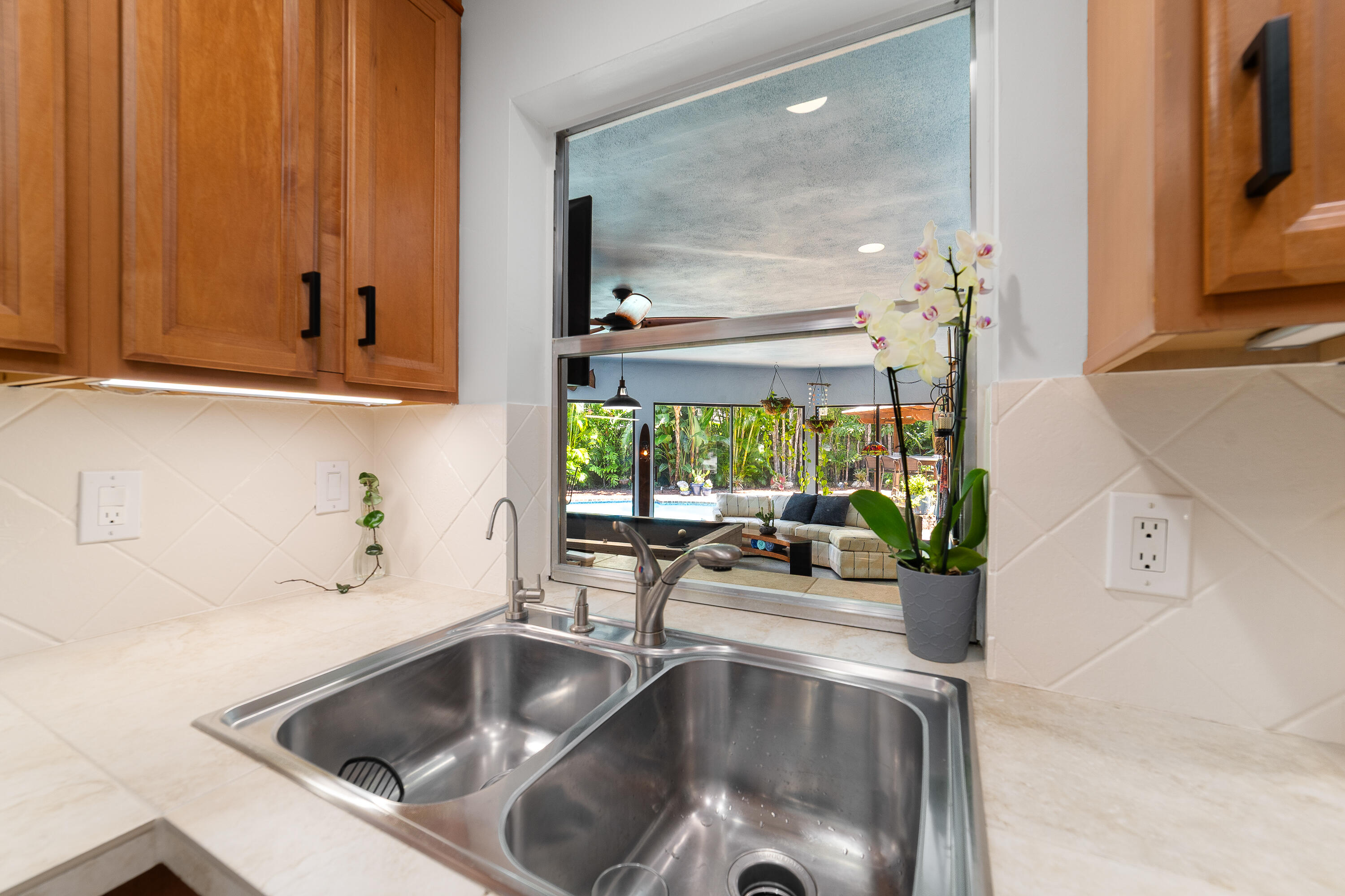 1721 Southwest 9th Street Boca Raton, FL 33486 - Photo 10 of 40 a kitchen with a sink and a large mirror next to a window