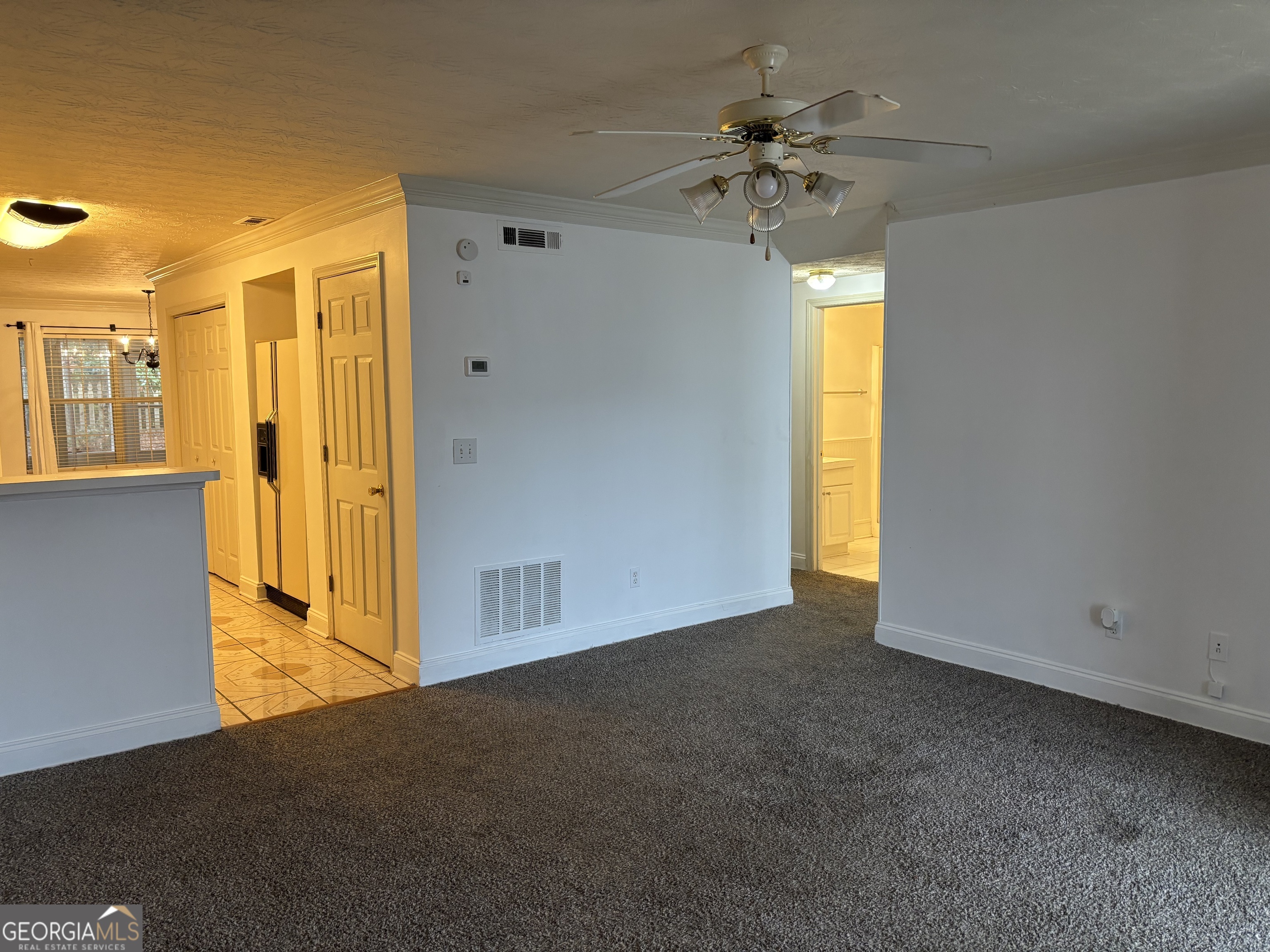 12 Intown Place Fayetteville, GA 30214 - Photo 3 of 12 en empty room with a window and a ceiling fan
