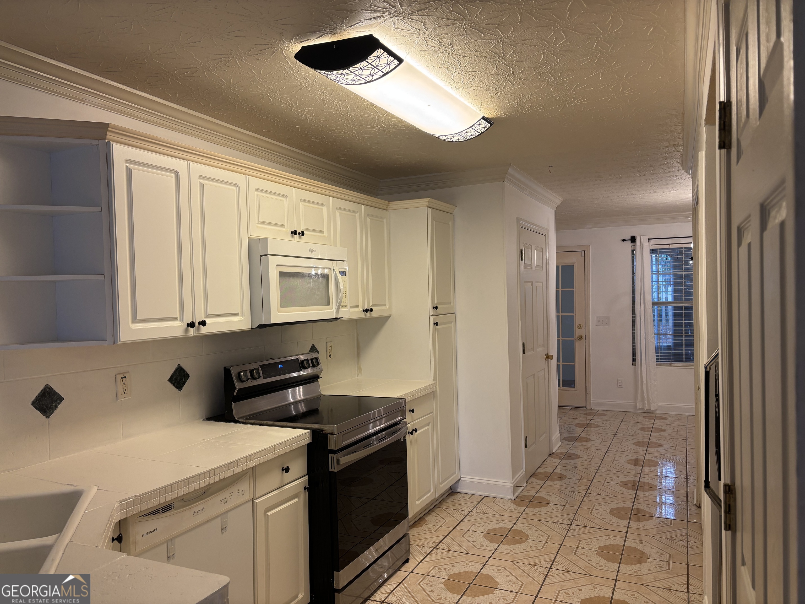 12 Intown Place Fayetteville, GA 30214 - Photo 4 of 12 a kitchen with a refrigerator and a sink