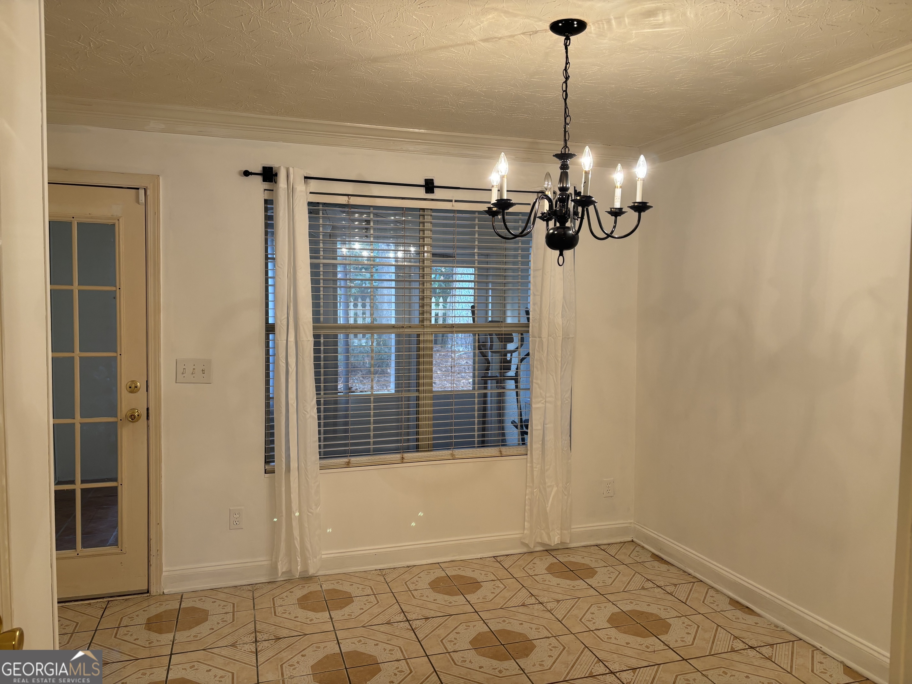 12 Intown Place Fayetteville, GA 30214 - Photo 7 of 12 a view of a room with a chandelier fan and windows