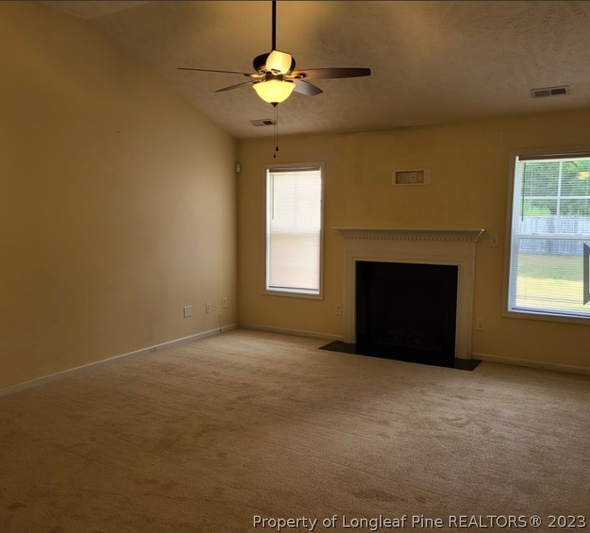 141 Roanoke Drive Raeford, NC 28376 - Photo 2 of 16 a view of an empty room with a fireplace and a window