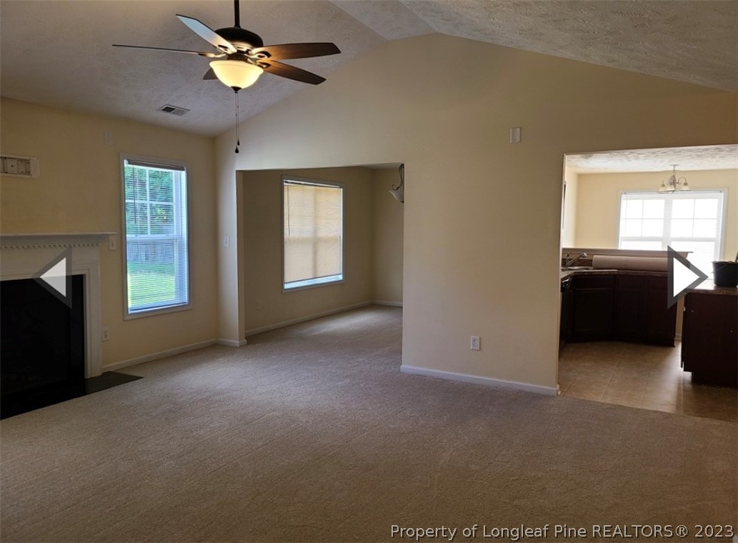 141 Roanoke Drive Raeford, NC 28376 - Photo 3 of 16 a view of an empty room with a window and a kitchen