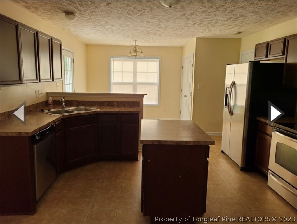 141 Roanoke Drive Raeford, NC 28376 - Photo 6 of 16 a kitchen with a sink and a refrigerator