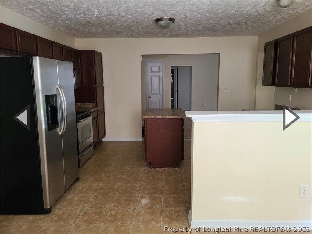 141 Roanoke Drive Raeford, NC 28376 - Photo 7 of 16 a kitchen with stainless steel appliances a refrigerator and a microwave