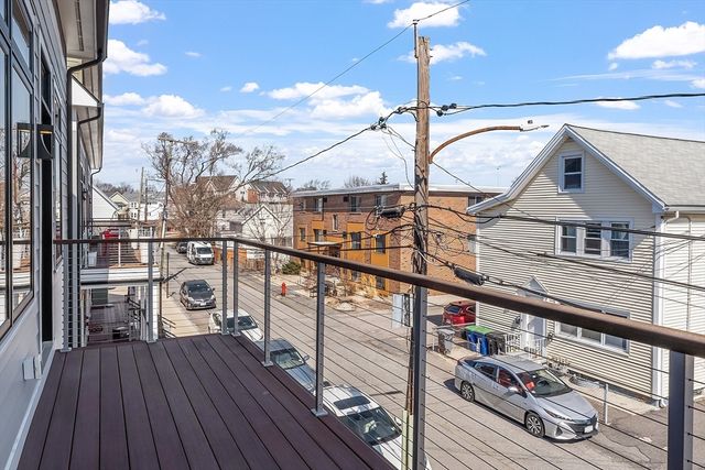 a view of a balcony with wooden floor