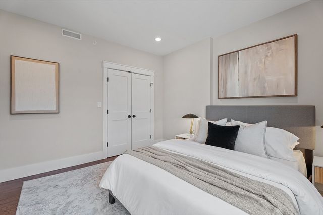 a bedroom with bed and wall painting