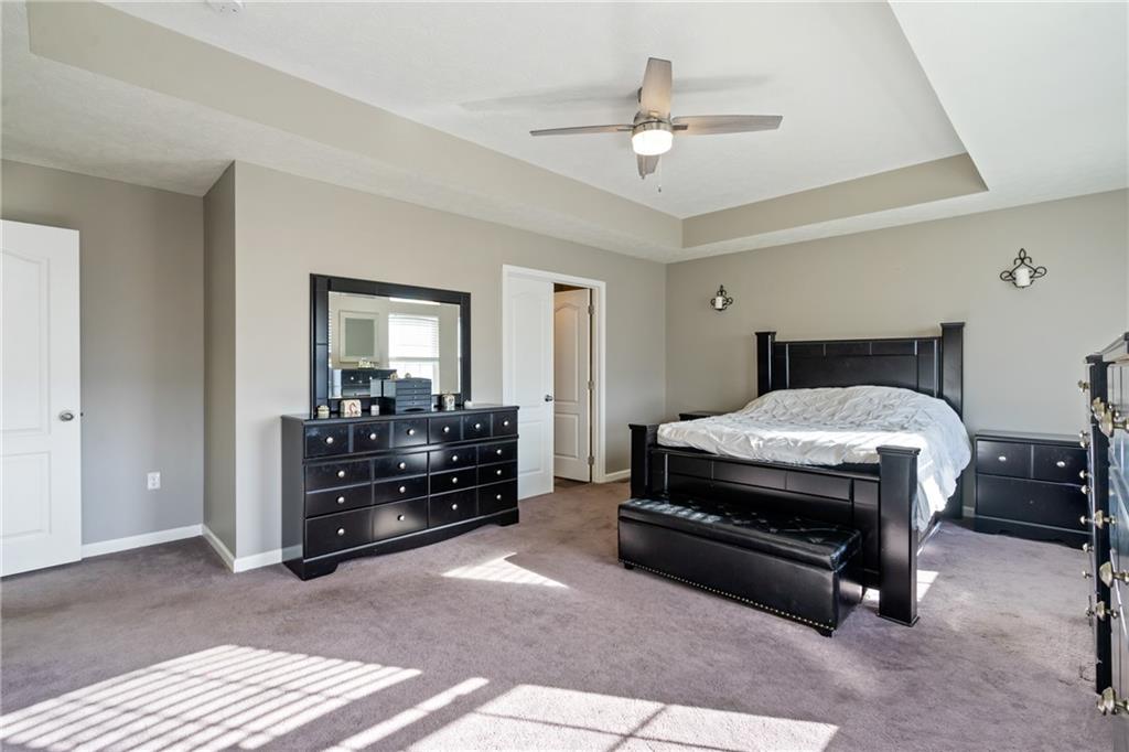 216 West Country Barn Road Houston, PA 15342 - Photo 27 of 34 a bedroom with a bed and a chandelier