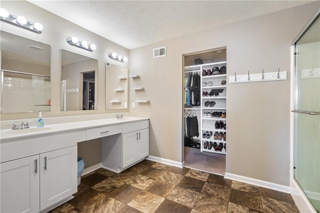 216 West Country Barn Road Houston, PA 15342 - Photo 28 of 34 a spacious bathroom with a sink a large mirror and a shower