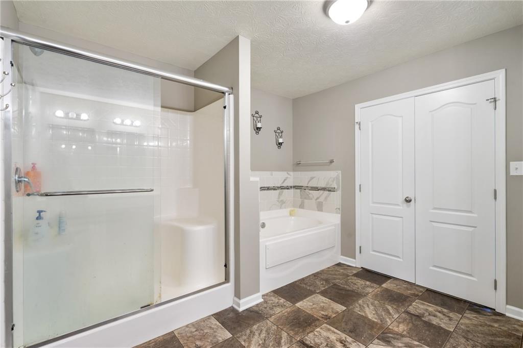 216 West Country Barn Road Houston, PA 15342 - Photo 29 of 34 a bathroom with a bathtub and a shower
