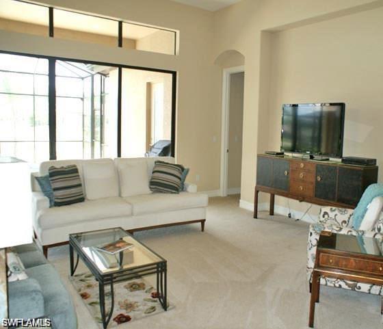 7414 Acorn Way Naples, FL 34119 - Photo 3 of 24 a living room with furniture and a flat screen tv
