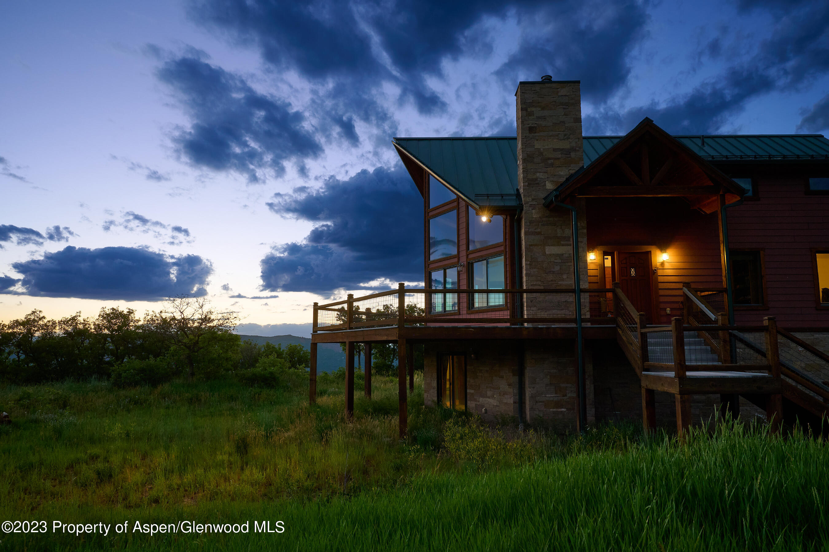 4001 Bear Ridge Road Basalt, CO 81621 - Photo 13 of 35 a backyard of a house with table and chairs