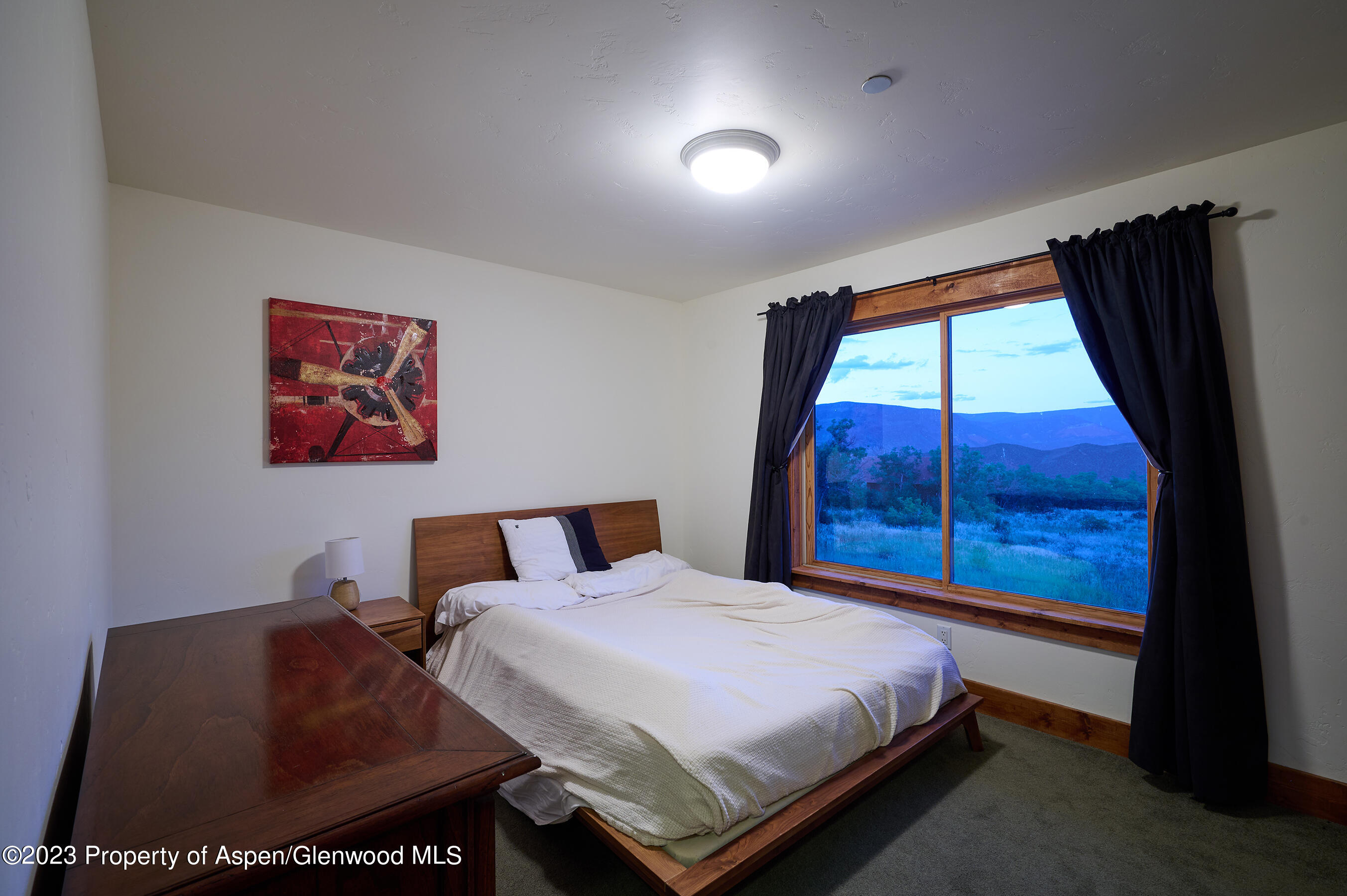 4001 Bear Ridge Road Basalt, CO 81621 - Photo 15 of 35 a bed sitting in a bedroom next to a window