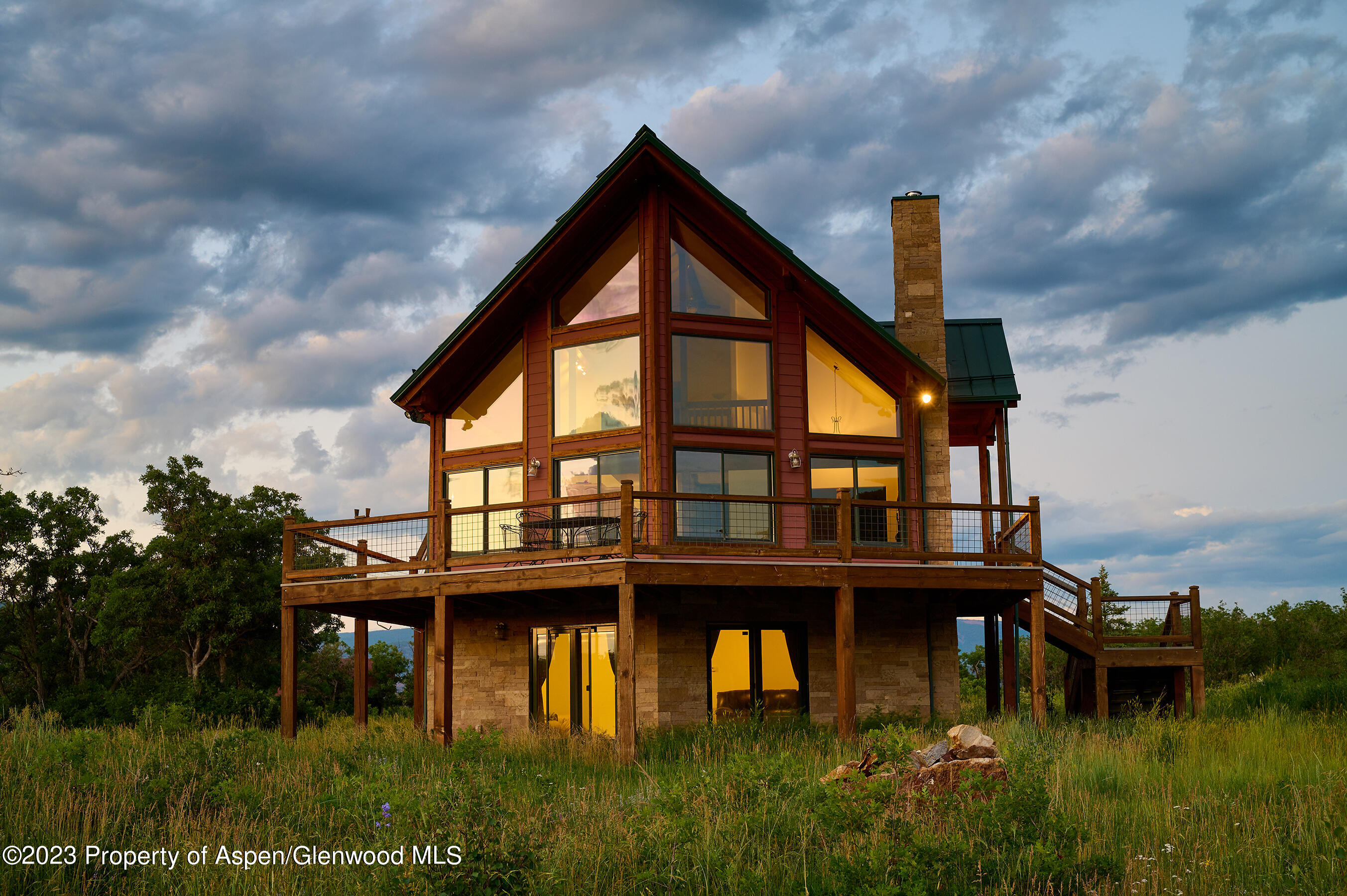 4001 Bear Ridge Road Basalt, CO 81621 - Photo 2 of 35 a backyard of a house with lake table and chairs