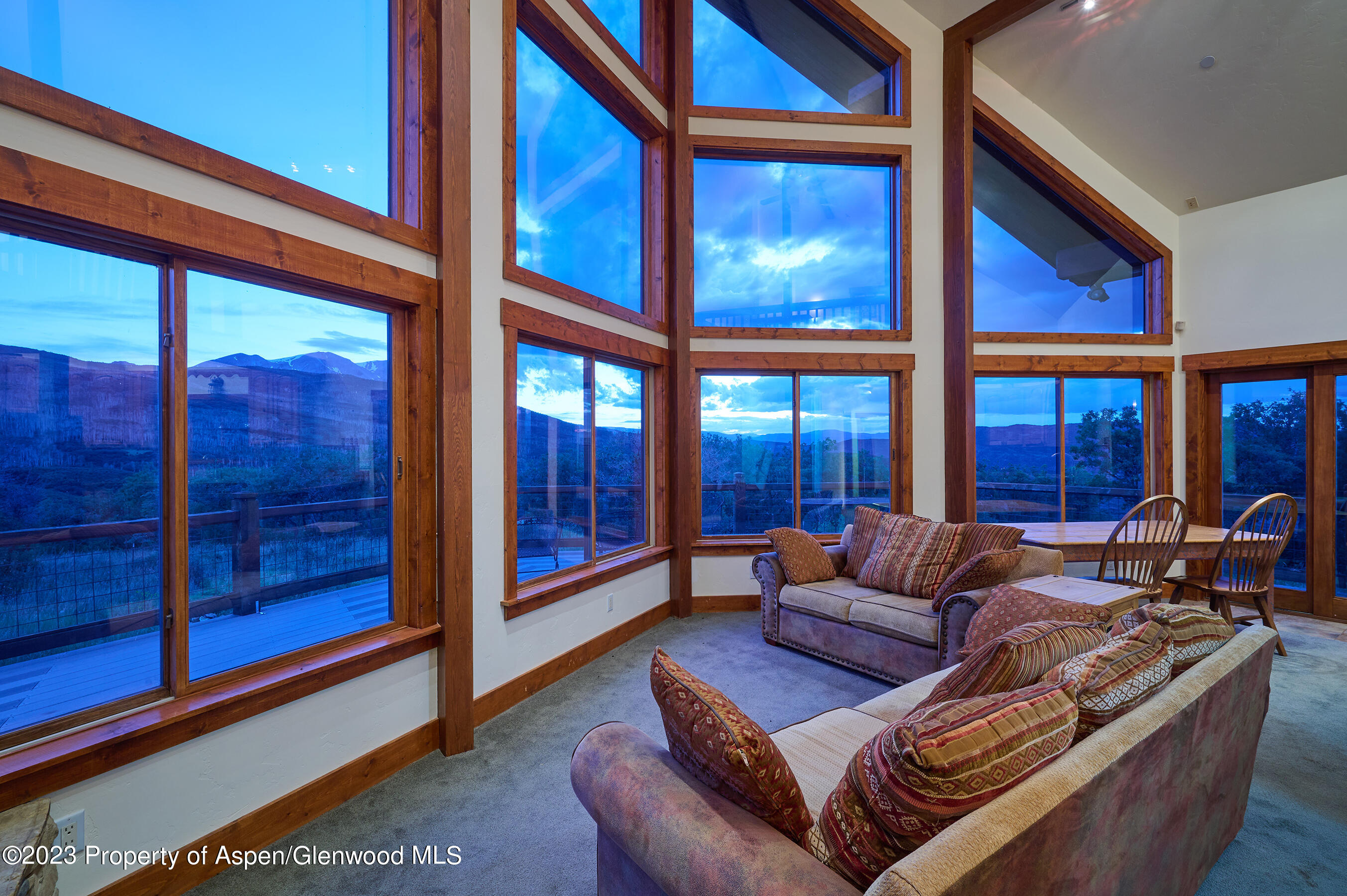 4001 Bear Ridge Road Basalt, CO 81621 - Photo 21 of 35 a living room with furniture a floor to ceiling window and potted plants