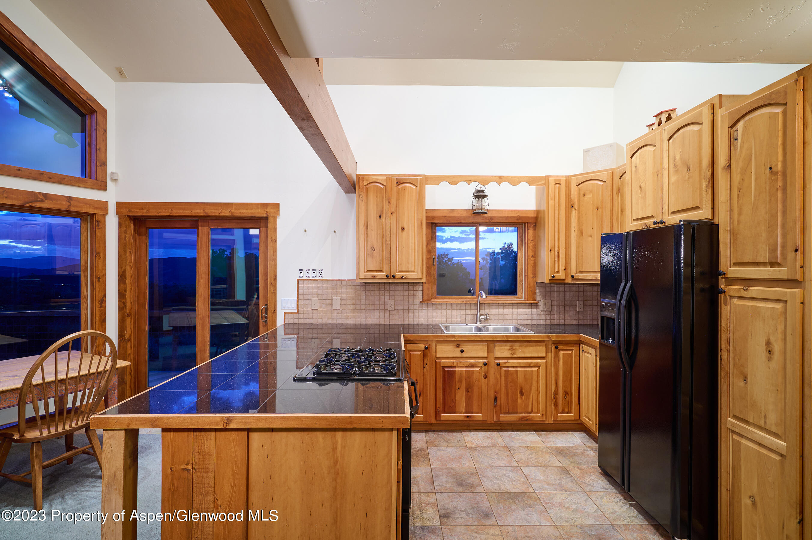 4001 Bear Ridge Road Basalt, CO 81621 - Photo 27 of 35 a kitchen with stainless steel appliances granite countertop a refrigerator a stove and a sink with wooden floor