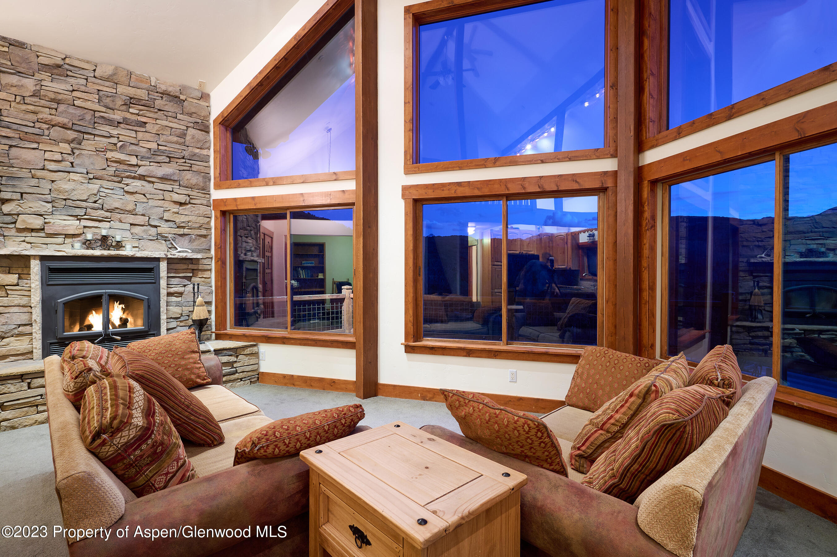 4001 Bear Ridge Road Basalt, CO 81621 - Photo 7 of 35 a view of a patio with couches chairs and a fireplace
