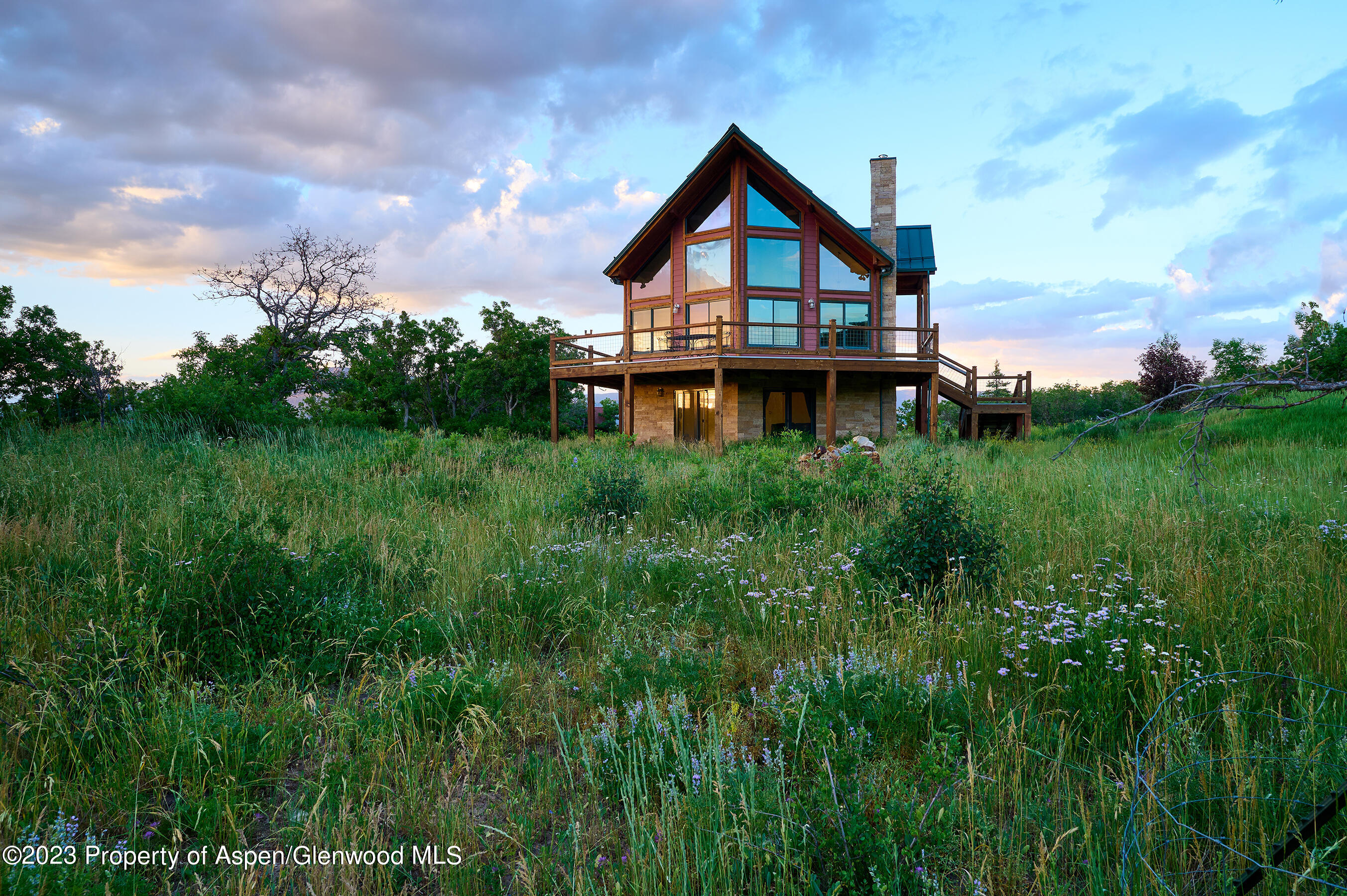 4001 Bear Ridge Road Basalt, CO 81621 - Photo 10 of 35 a view of a big house with a big yard and large trees