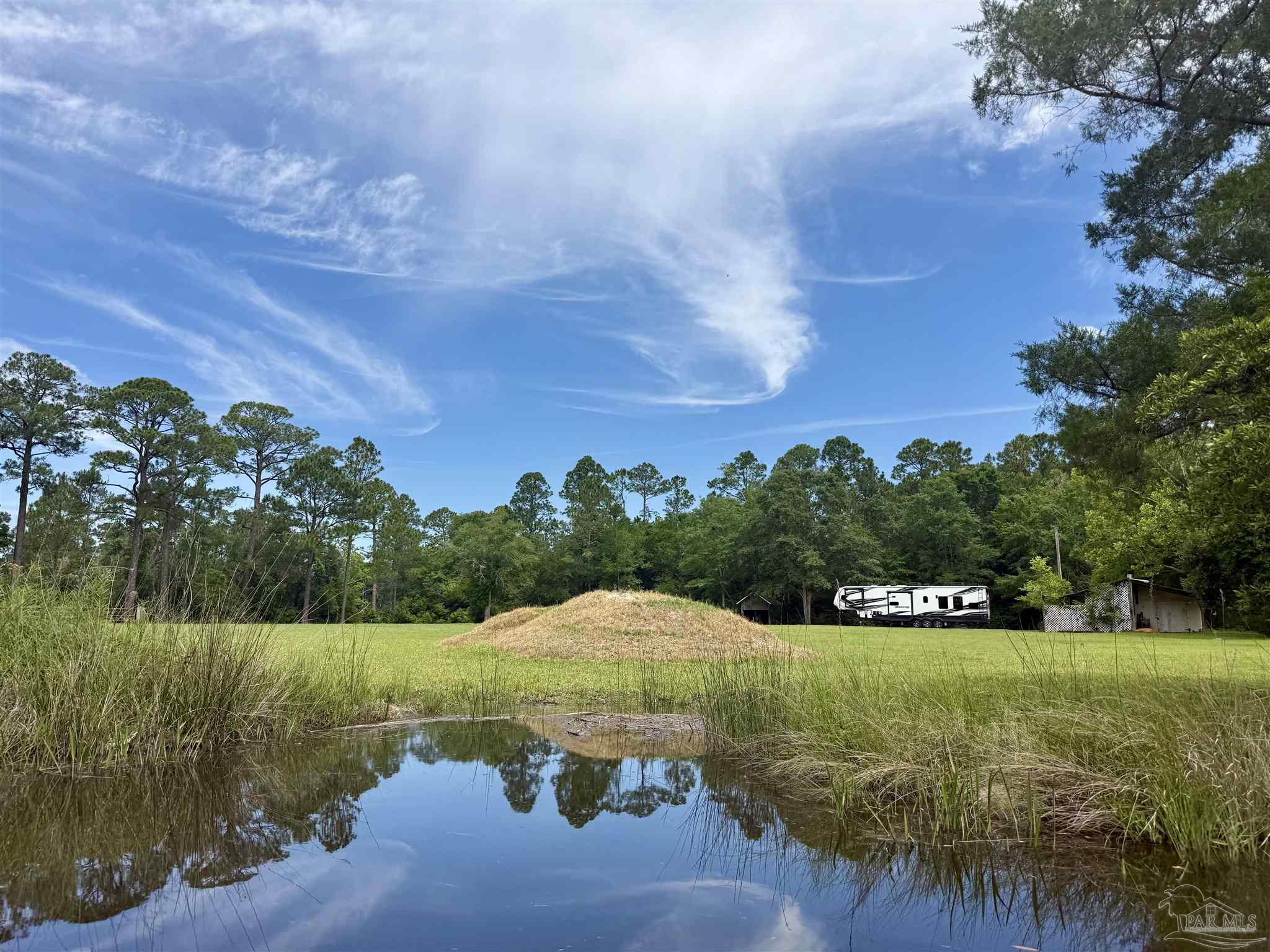 7524 Petersen Point Road Milton, FL 32583 - Photo 11 of 26 a view of a lake with a yard
