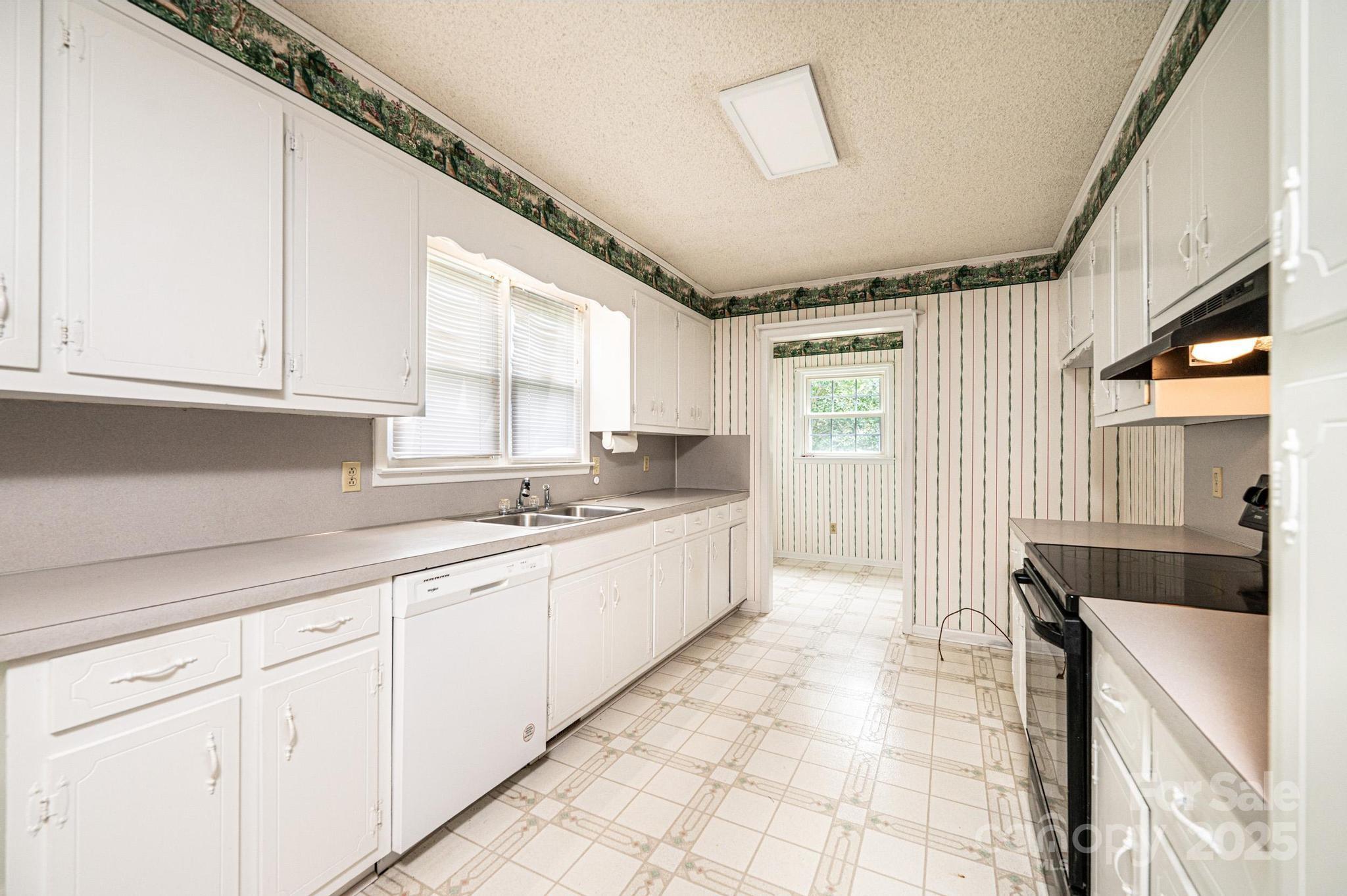 2541 Raintree Street Connelly Springs, NC 28612 - Photo 11 of 46 a large white kitchen with a sink and cabinets
