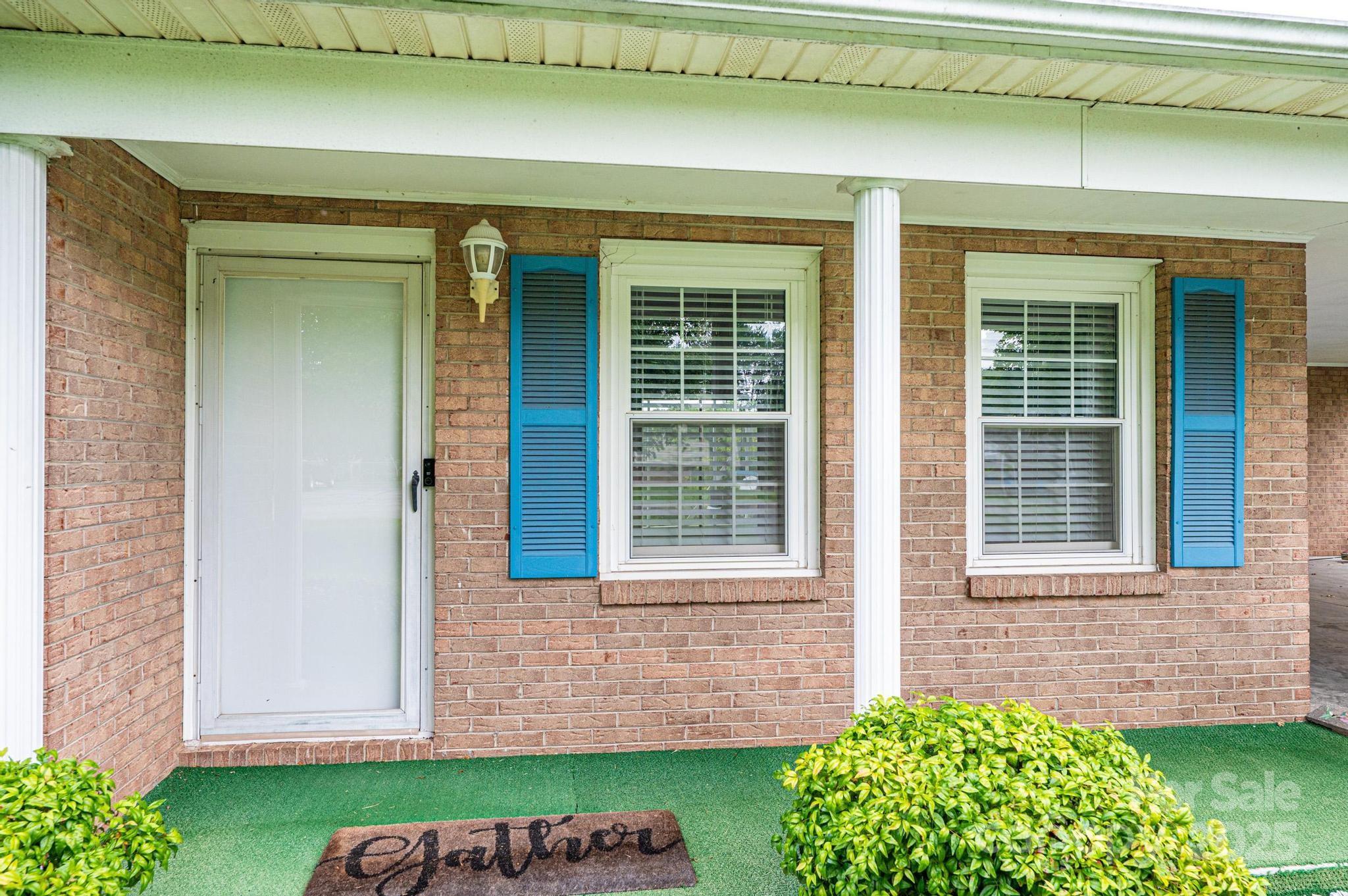 2541 Raintree Street Connelly Springs, NC 28612 - Photo 2 of 46 a front view of a house with a garden