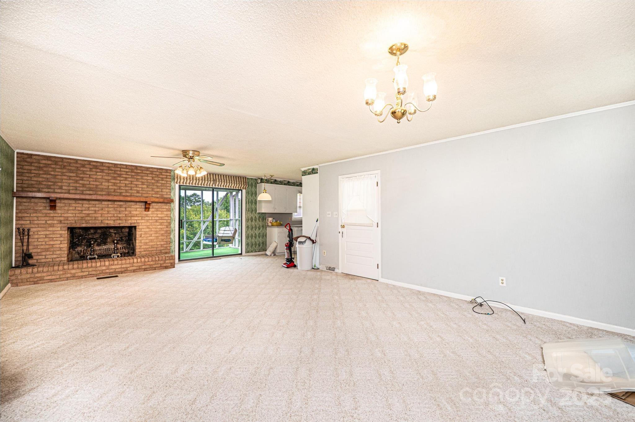 2541 Raintree Street Connelly Springs, NC 28612 - Photo 3 of 46 an empty room with windows and fireplace