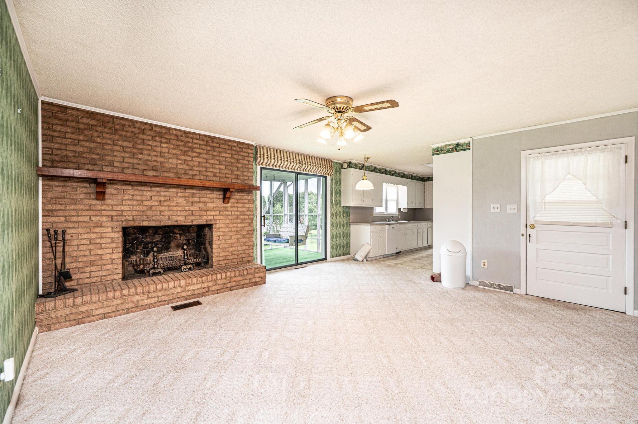 2541 Raintree Street Connelly Springs, NC 28612 - Photo 5 of 46 a view of an empty room with a fireplace and a window