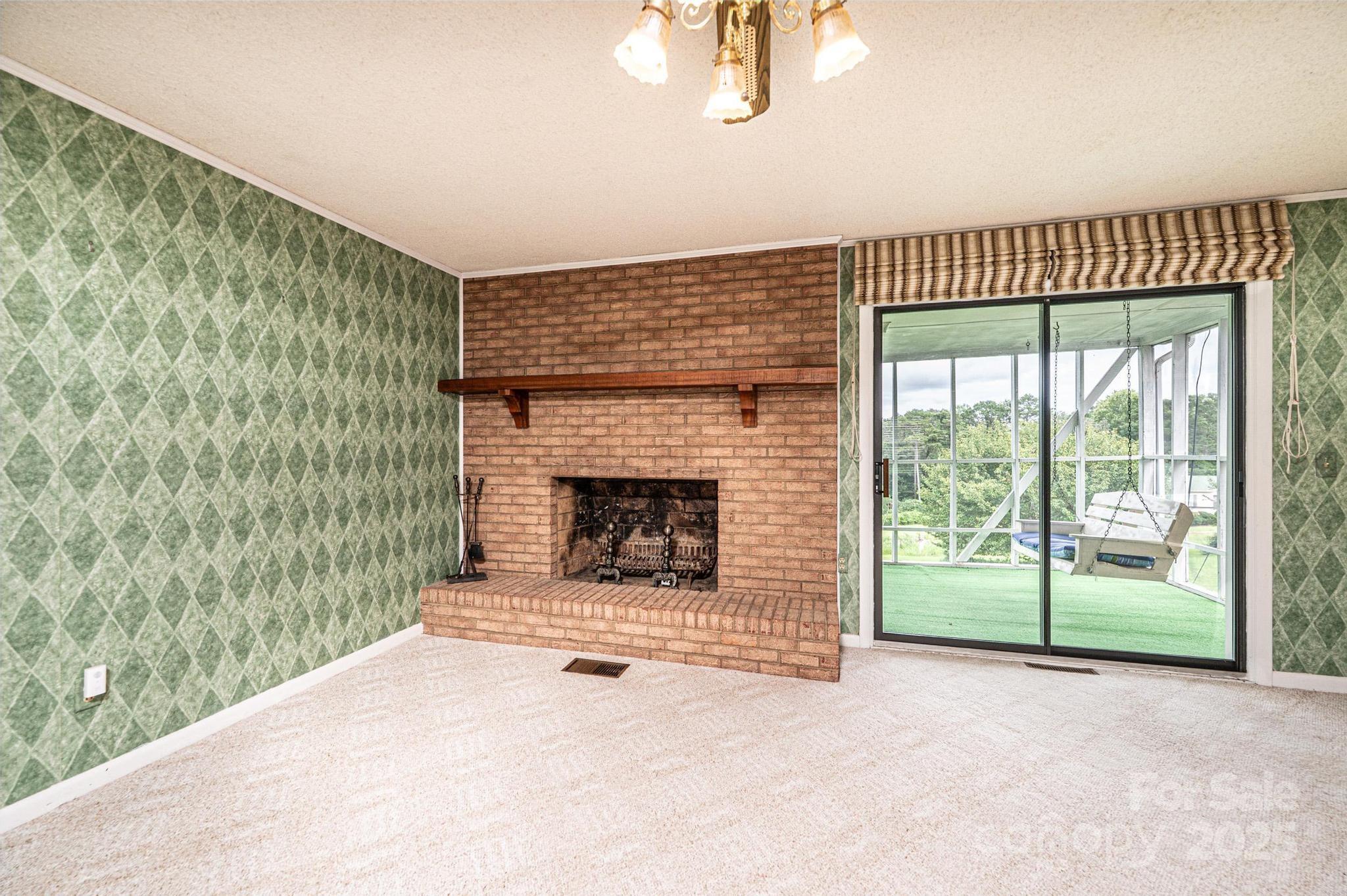 2541 Raintree Street Connelly Springs, NC 28612 - Photo 6 of 46 a view of empty room with fireplace and fan