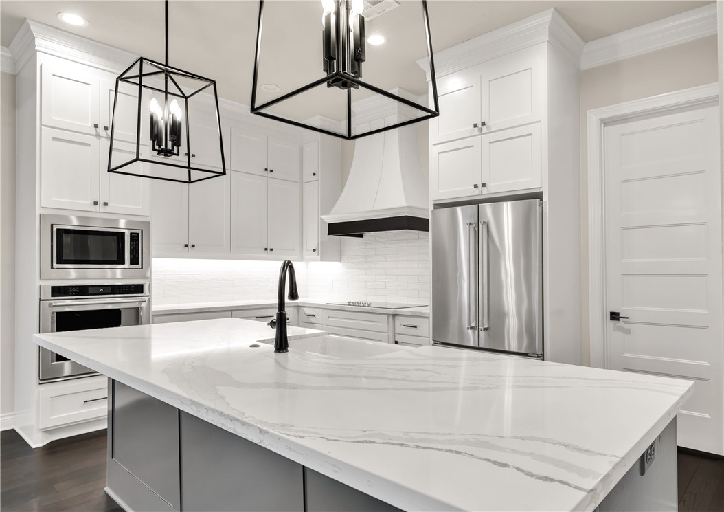 1736 Blanco Bend Drive College Station, TX 77845 - Photo 2 of 36 a kitchen with a sink a counter space and stainless steel appliances