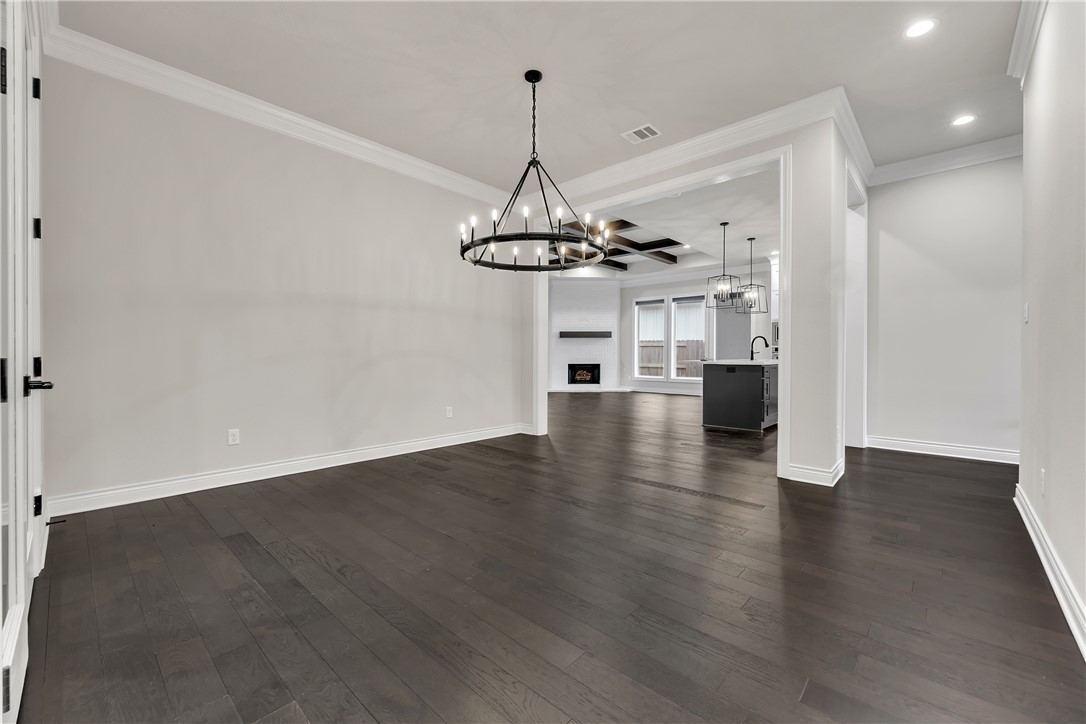 1736 Blanco Bend Drive College Station, TX 77845 - Photo 29 of 36 a view of a hallway with wooden floor and chandelier