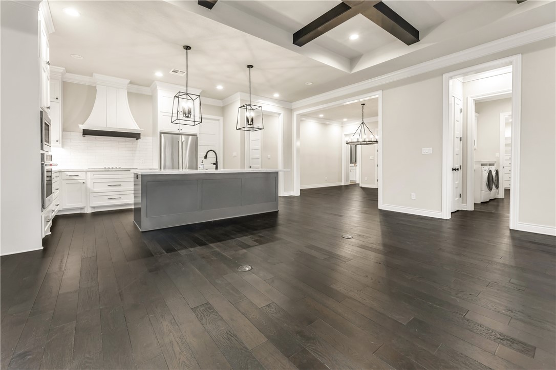 1736 Blanco Bend Drive College Station, TX 77845 - Photo 3 of 36 a view of a living room and kitchen with stainless steel appliances wooden floor