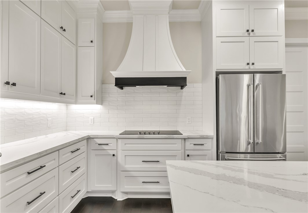 1736 Blanco Bend Drive College Station, TX 77845 - Photo 5 of 36 a kitchen with white cabinets and a stove