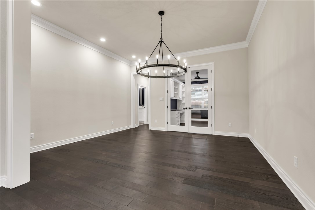 1736 Blanco Bend Drive College Station, TX 77845 - Photo 7 of 36 a room with wooden floor a chandelier and windows
