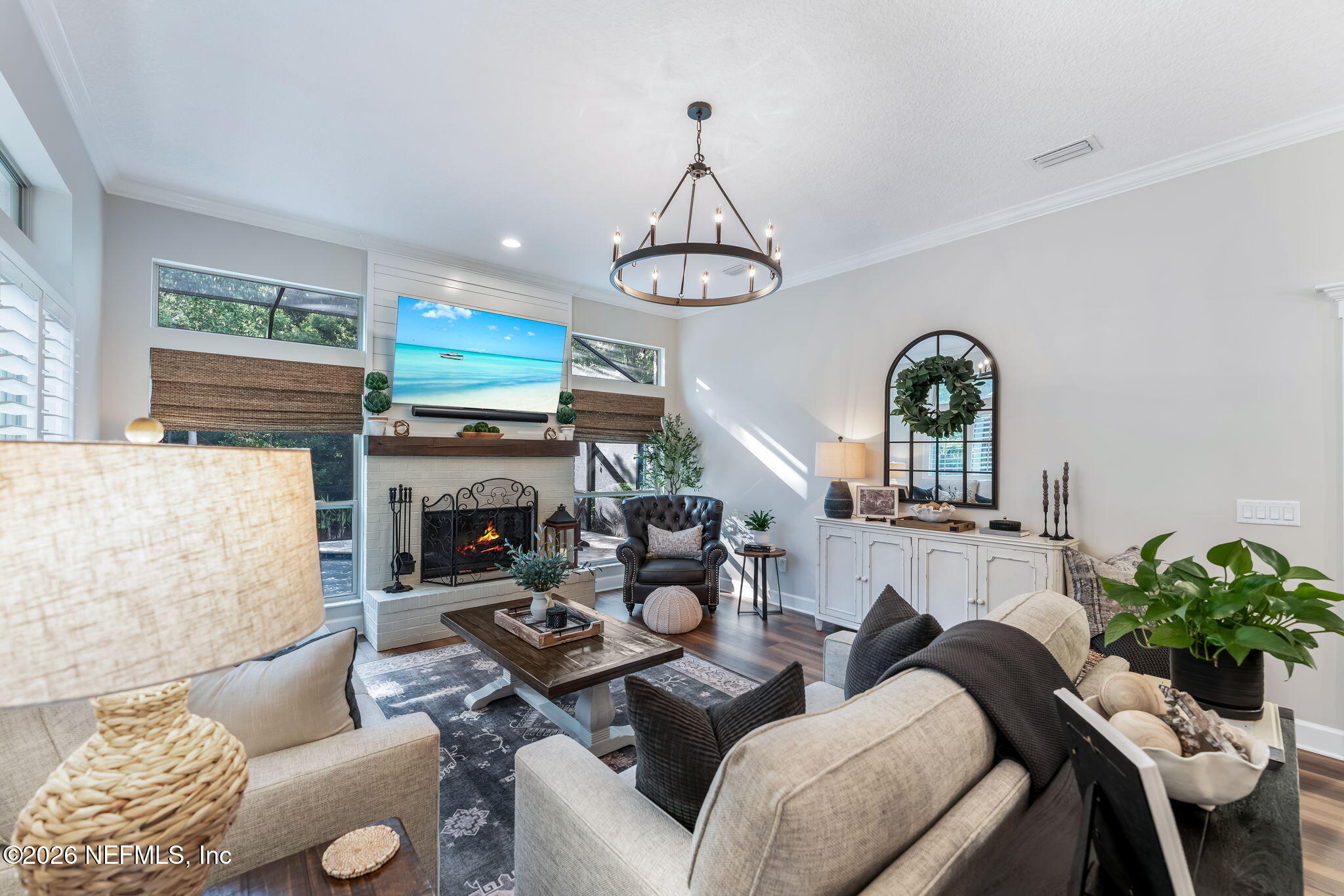 1204 Creek Bend Road St. Johns, FL 32259 - Photo 38 of 107 a living room with furniture a fireplace and a chandelier
