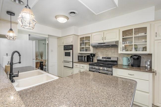 2404 Crestview Circle Irving, TX 75062 - Photo 13 of 39 a kitchen with stainless steel appliances kitchen island granite countertop a stove and cabinets