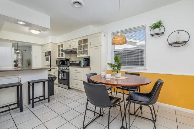a dining room with furniture and window
