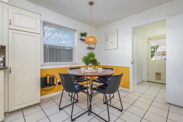 a view of a dining room with furniture wooden floor and chandelier