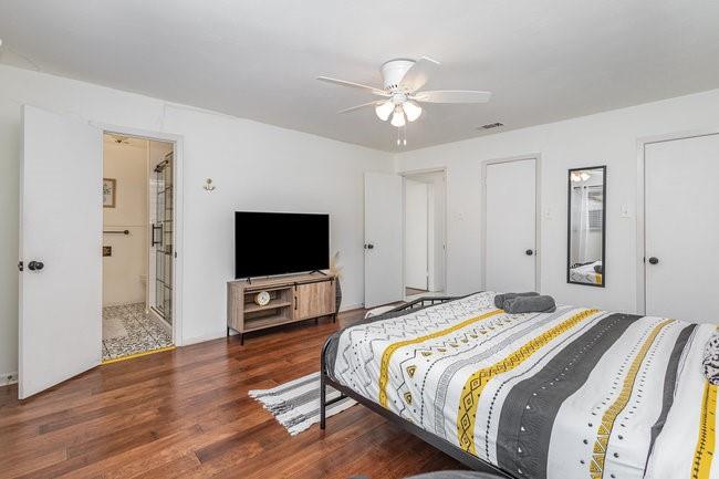 2404 Crestview Circle Irving, TX 75062 - Photo 18 of 39 a bedroom with a bed and a flat screen tv